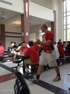 Lucas Hubbard, in his LHS Football jersey, participates in a lunchtime scavenger hunt competition.
