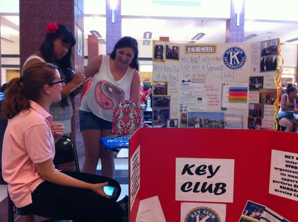 Liz Moore gives information about Key Club to Emily Cavell and Alison Eckloff.