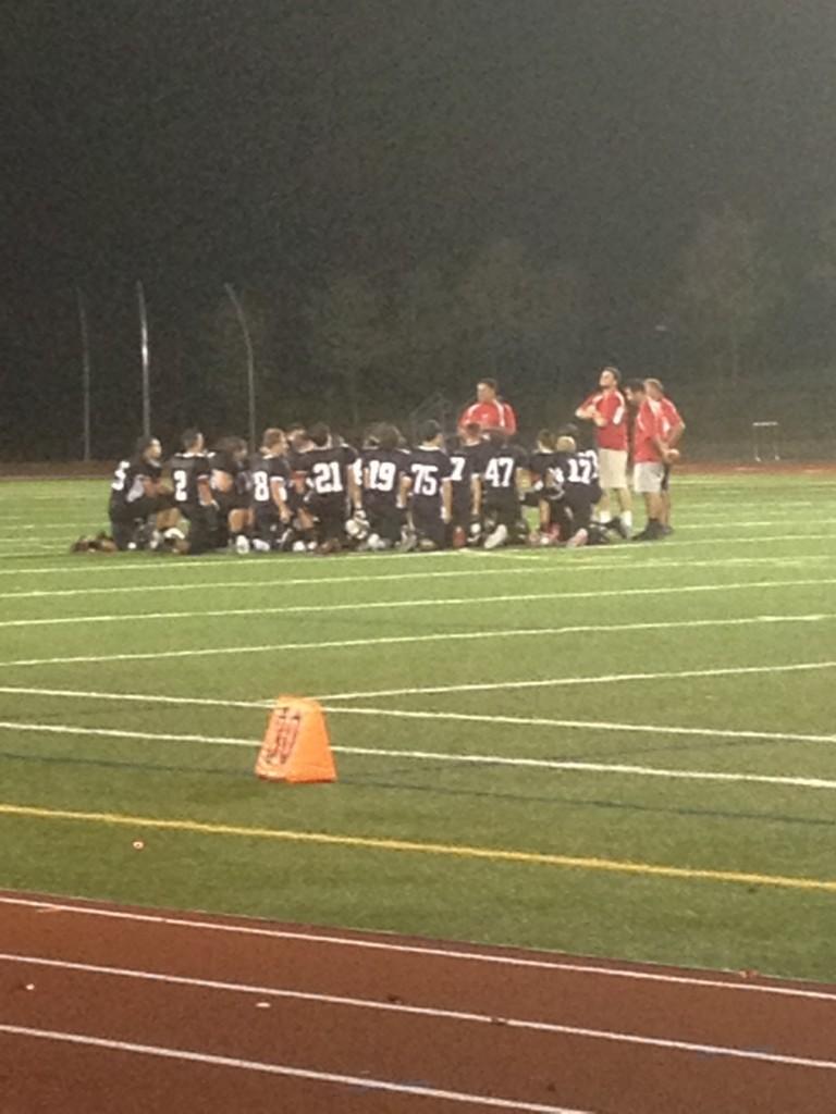 Linganore JV football huddles after the game.
