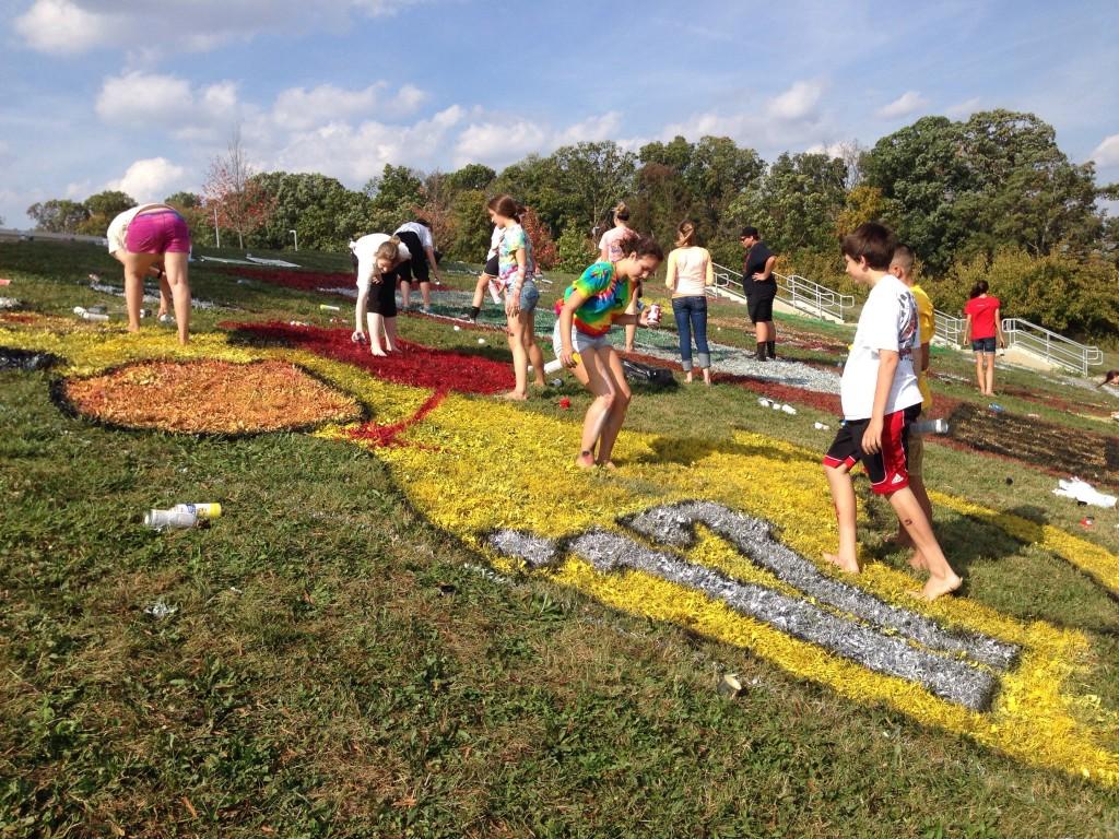 Members from the Freshman Class paint a Lucky Duck at the Hill Decorating event Sunday.