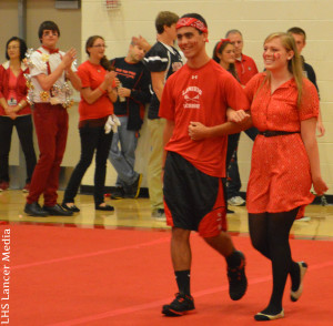 Homecoming court seniors Jack Garabedian and Grace DeMember walk out to participate in one of the competitions
