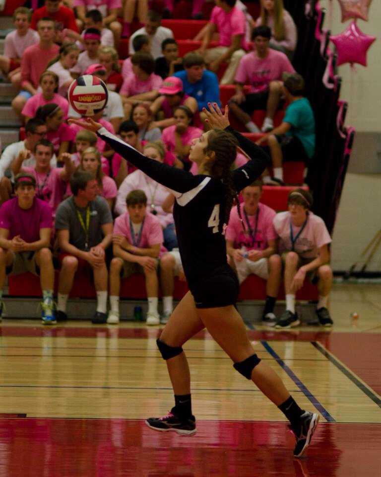 Melissa Kolick serves in front of the pinked-out student section last night at the annual Dig Pink match.