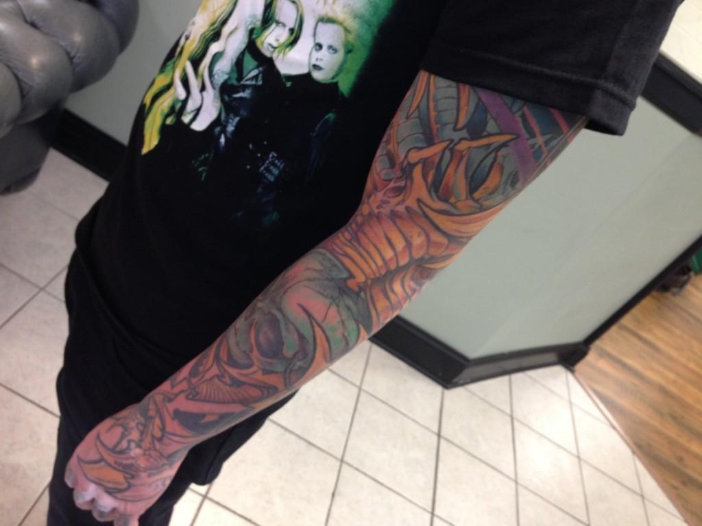 Tommy, a tattoo artist at Bulletts Ink in Mt. Airy, shows off his sleeve. 