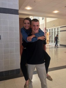 Sophomores Wade Steiren and Elizabeth Coletti piggy back riding in an empty hallway.