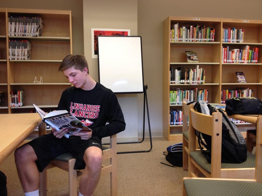 Freshman Jac Medve studies in the media center third period.