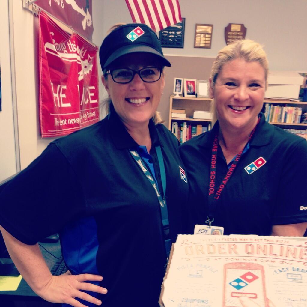 Mrs. Cassidy and Mrs. Knight dressed as pizza delivery persons.