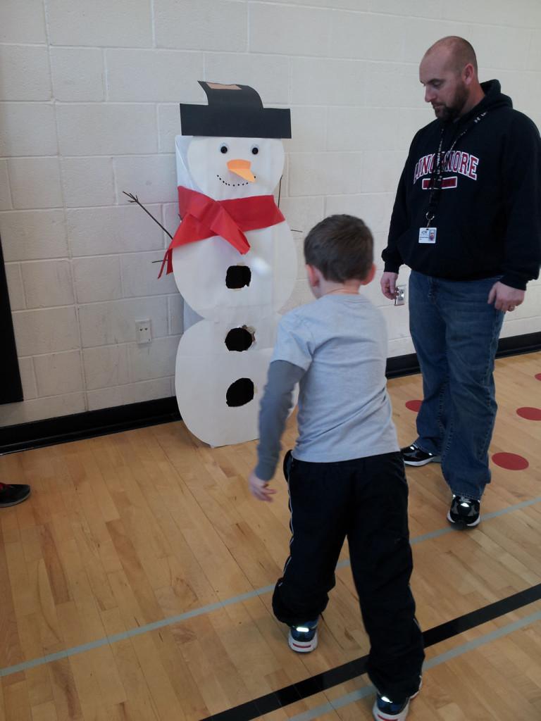 A visiting student enjoys the snowman ball toss.