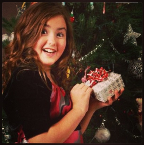 A young Callia Tweedell opening Christmas gifts