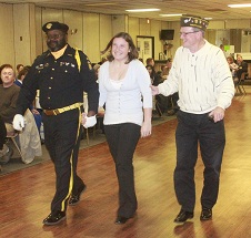  Abagayle Hilton is escorted by an honor guard (left) and  Mt. Airy VFW member Alan Yetter (right). 