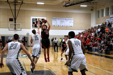 Jack Staub raises up over an Oakdale defender for a jump shot. Photo courtesy of Pete Austin.