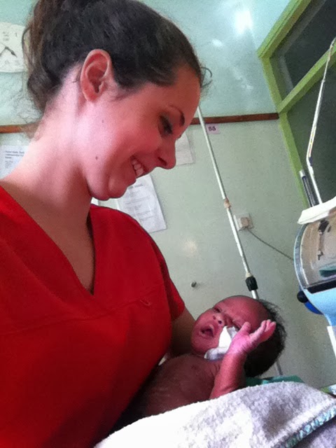 Breana McKinnon holds a newborn infant in her nursing job. 