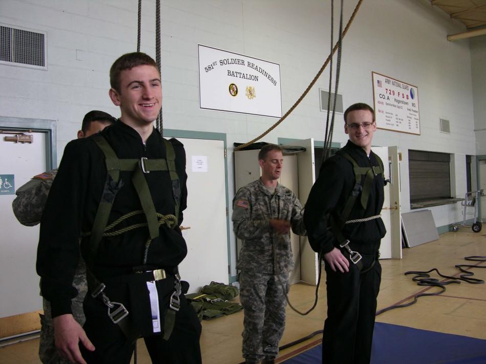 Brady Brockdorff and Shane Stickly being hooked in to simulate being lifted by a helicopter