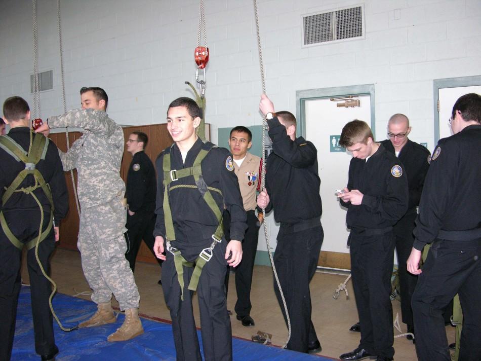 Andrew Longo and Trevor Jarvis assisting in lifting a student up. 