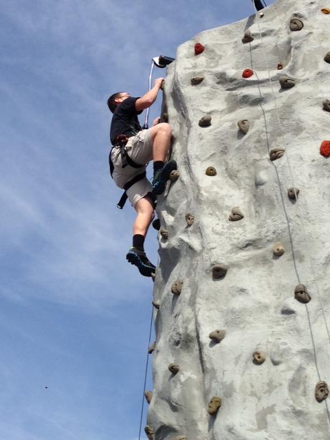 Brook Lee climbs the rock wall. 