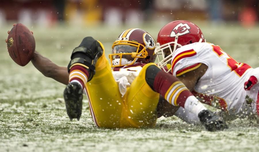 Washington Redskins quarterback Robert Griffin III (10) was tackled in the second quarter by Kansas City Chiefs strong safety Eric Berry (29) at FedEx Field in Landover, Md., Sunday, Dec. 8, 2013. Griffin III lost the football but was ruled down by contact. The Chiefs won 45-10. (David Eulitt/Kansas City Star/MCT)