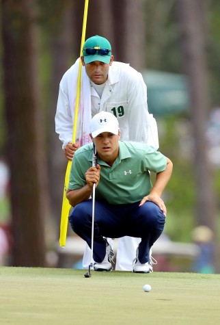 Jordan Spieth looks over his par putt on the third green with caddie Michael Greller during the final round of The Masters in Augusta, Ga., Sunday, April 13, 2014. (Curtis Compton/Atlanta Journal-Constitution/MCT)
