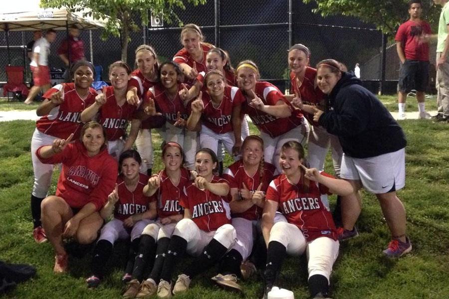 The softball team poses after their win on Tuesday night.
