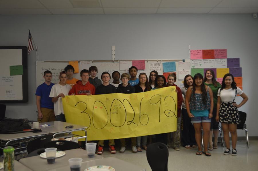 Brittney Garsts Read 180 class holsd a banner that signifies their accomplishment of reading 3 million words.
