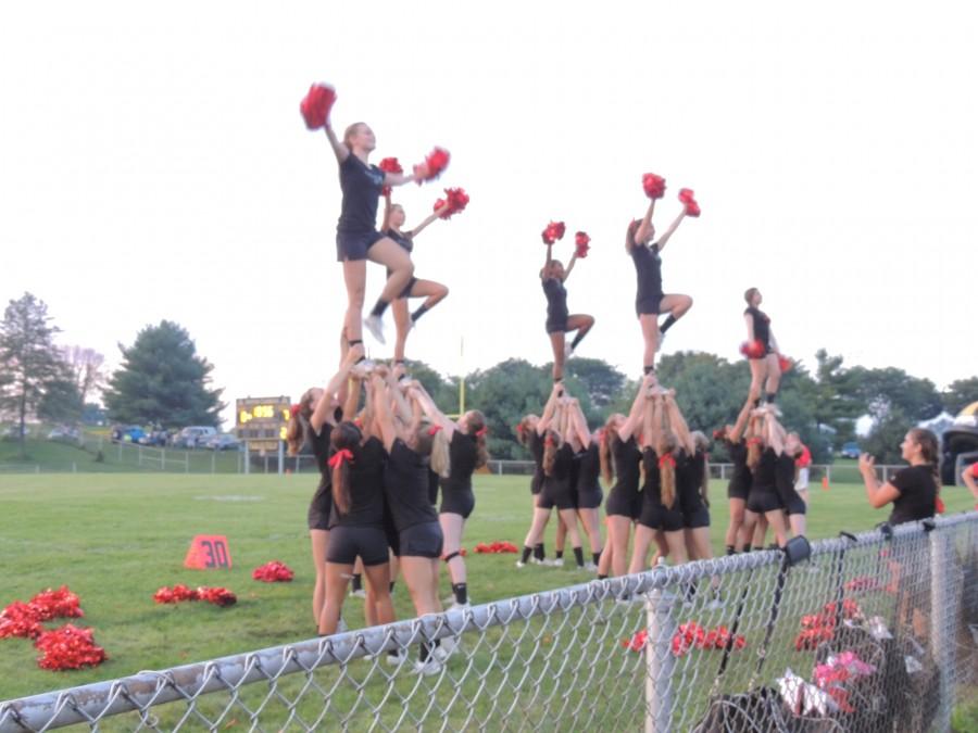 Lancer cheerleaders do a stunt at the first game of the season against South Carroll