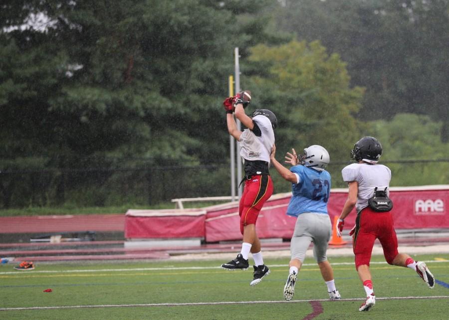 Junior Dan Ross makes a leaping catch against South River.