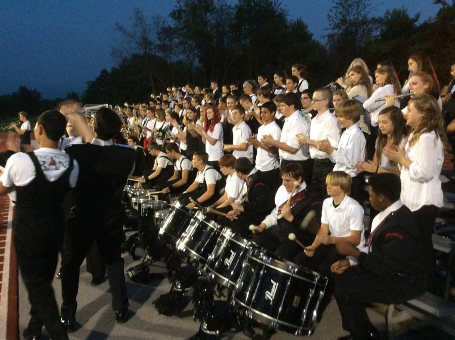 Senior+Shawn+Verma%2C+pit+percussion+section+leader%2C+rallies+the+eighth+grade+students.