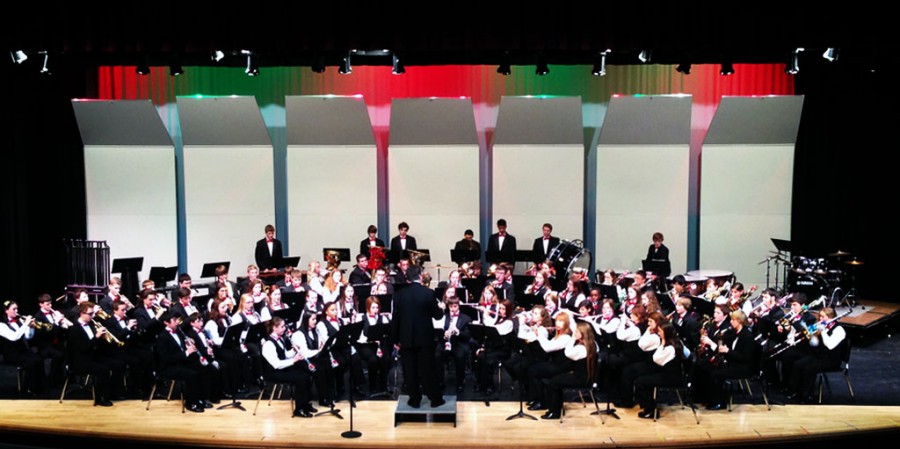 The concert band performs on stage
