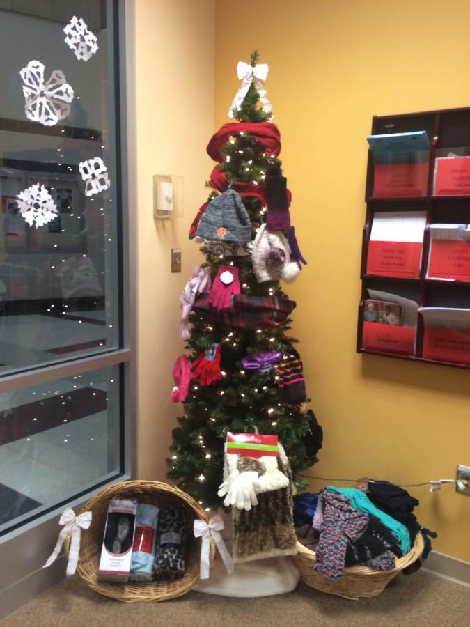 The tree in the front office stands tall and proud, surrounded by thoughtful donations. 