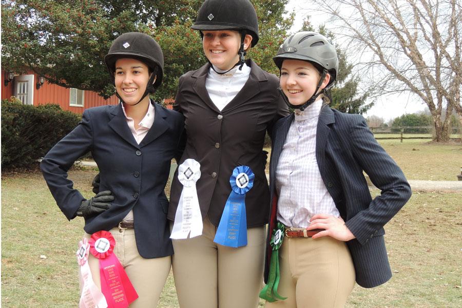 Magena Straight, Katie Gallagher, and Jessica Mitchell posing for a picture with their ribbons after they are all done showing. 