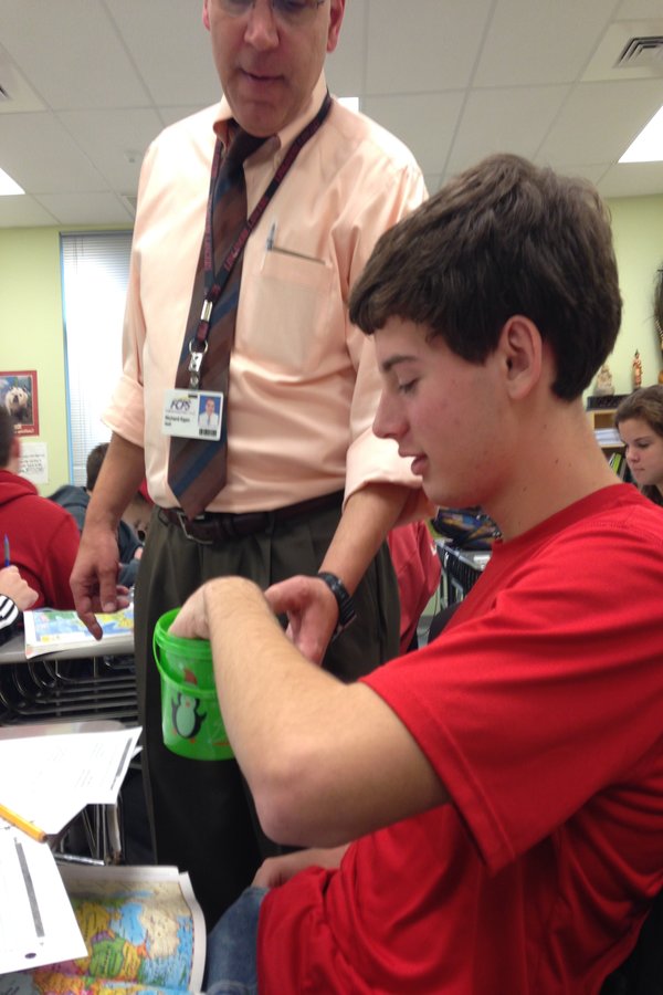Mr. Rich Egan collects a donation from sophomore Robbie Miley in AP World History on Giving Tuesday.
