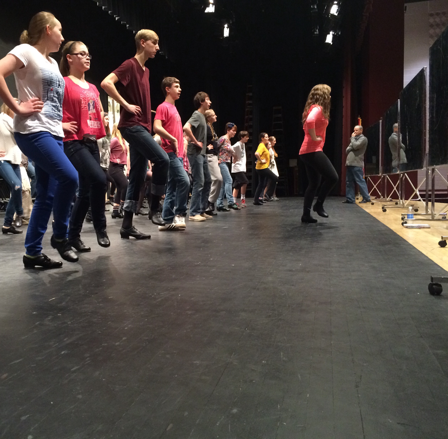The cast of the spring musical Anything Goes practice receive a lesson in tap dancing.