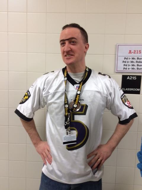 Mr Burch wears a Ravens jersey with a drawn in uni brow. 