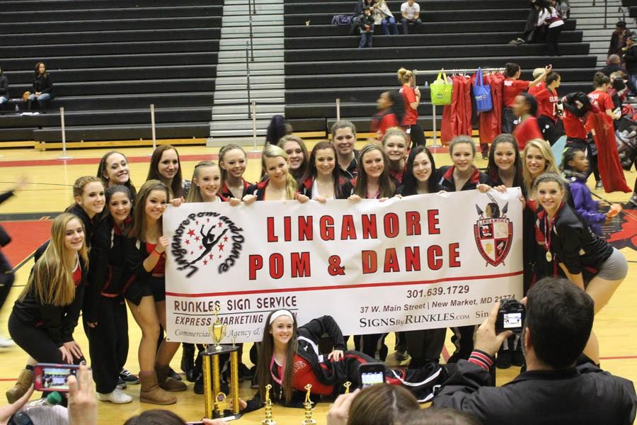 Pom and Dance team poses with awards 