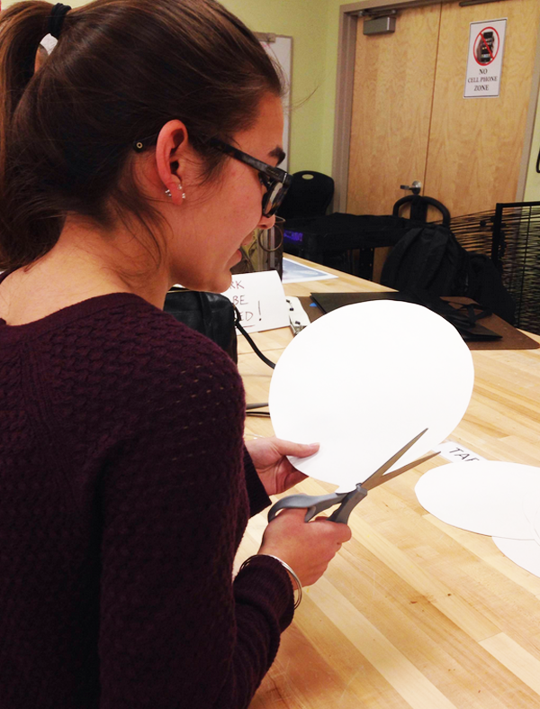 Art Honor Society member Haylie Kohn cuts out a balloon in preparation for the annual art show in April.