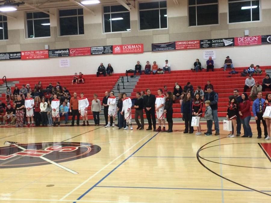 Varsity  basketball team is recognized at senior night.
