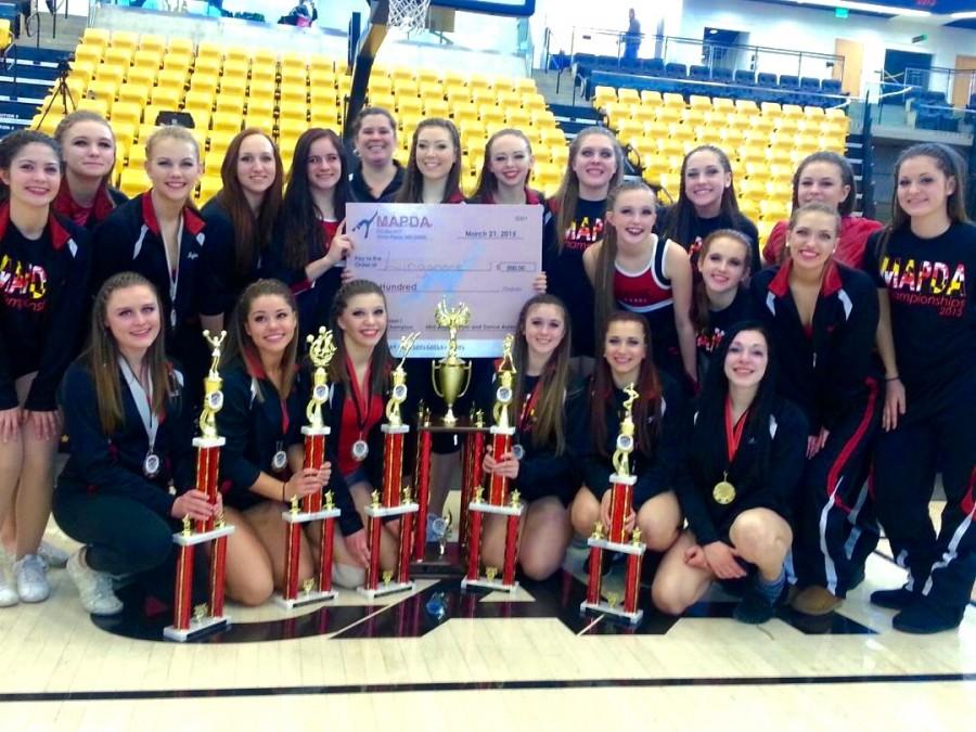 The Pom and Dance Team poses with their awards for several pictures after their State Competition.