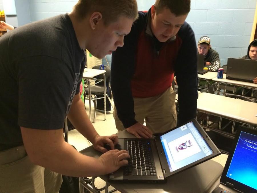 Seniors Mike Fink and Chris Cooper create the official Make it Happen logo at their project meeting. 