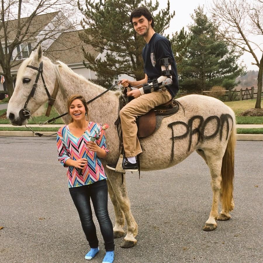 A surprised Olivia DuBro stands next to her boyfriend Joe Calder as he asks her to prom on the horse.