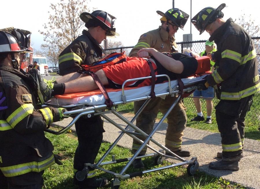 In the simulated crash, Justin Knotts is wheeled away by the Libertytown Fire Department.