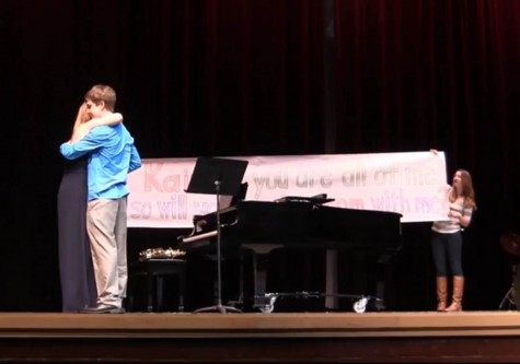 Brandon Kleinmann promposes to his girlfriend, Kaitlin Byrnes, on stage at the Mr Linganore competition on March 8. 