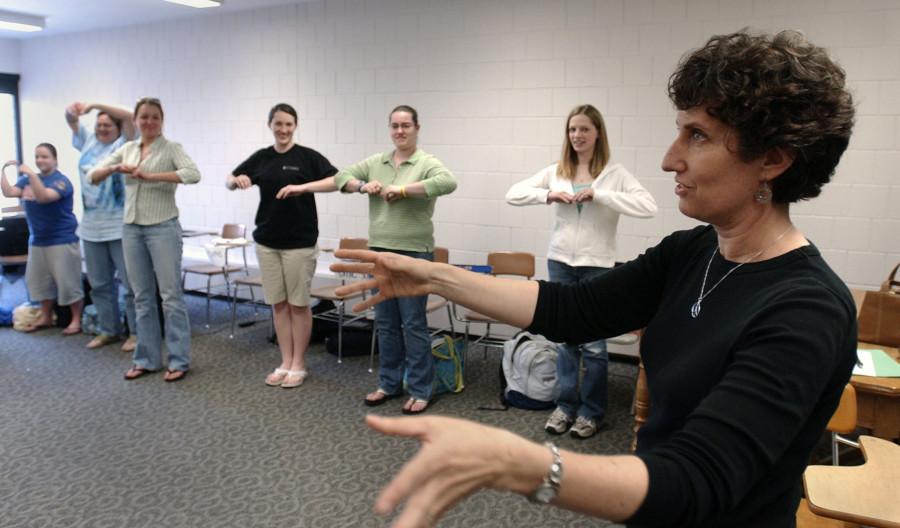 Patty Gordon, foreground, a freelance sign language interpreter and teacher, leads an exercise during a sign language interpreting class. 