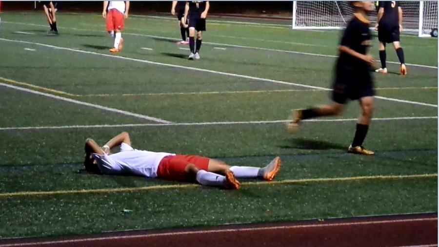 Luke Staley falls on the field after narrowly missing a goal.