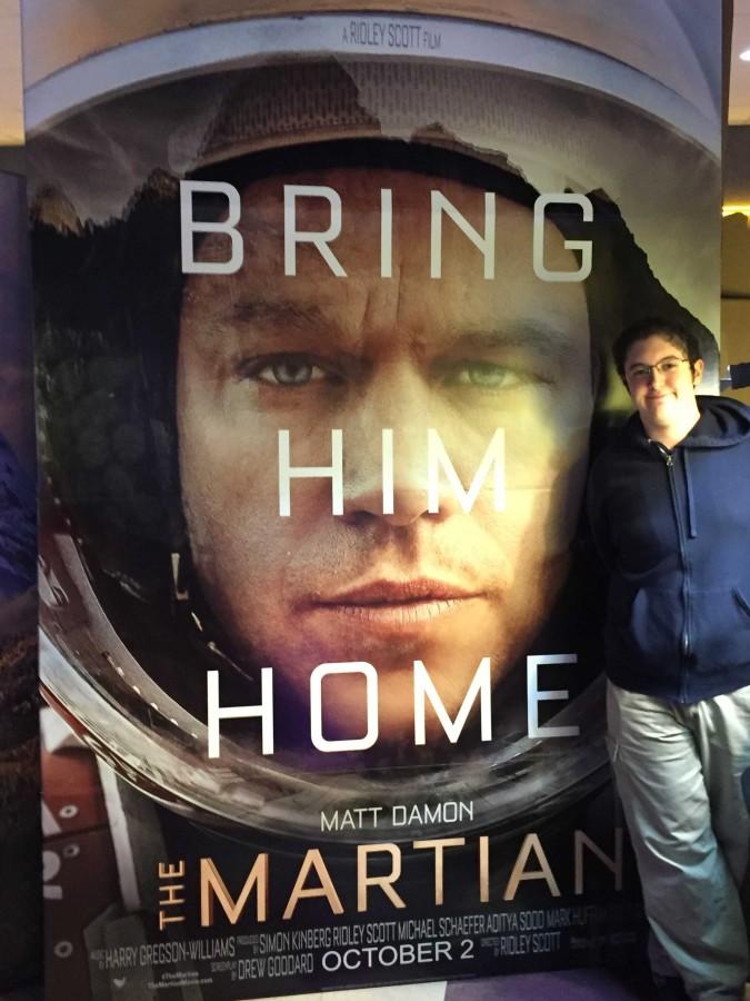 I stand beside the rather large promotional cutout for The Martian.