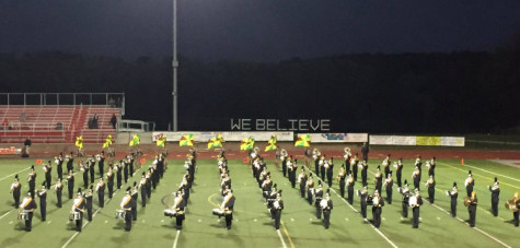 The marching band and color guard performs at the homecoming game.