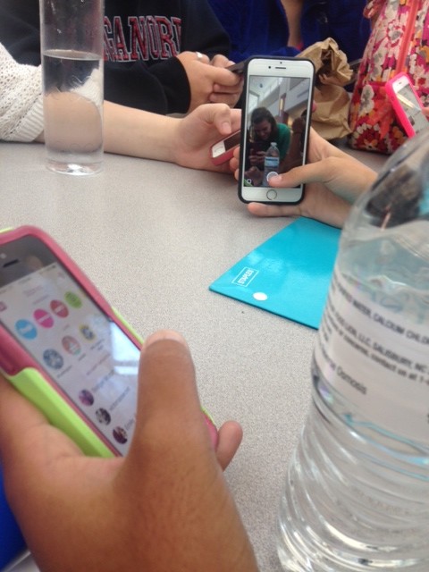 Students enjoy lunch while sending snaps to their friends. 