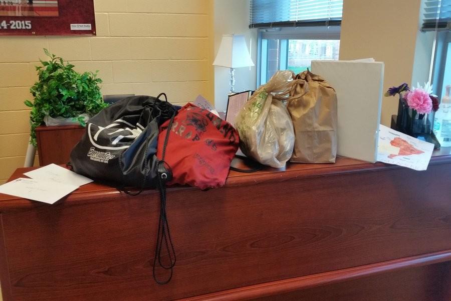 On any school day before 10 a.m., drop-off items stack up in the front office.