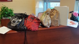 On any school day before 10 a.m., drop-off items stack up in the front office.
