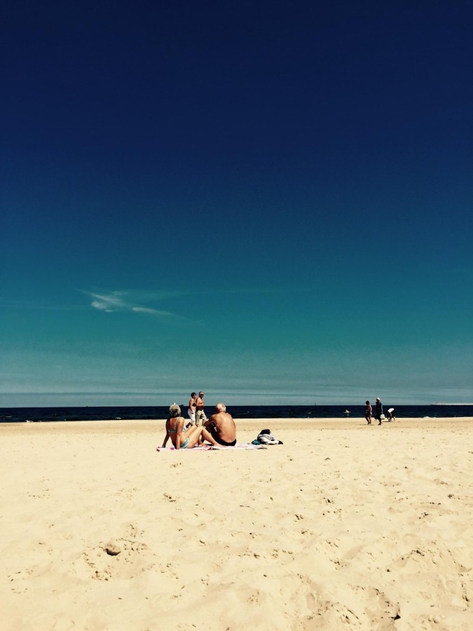 Couple relaxes on a white sand beach in Poznan, Poland