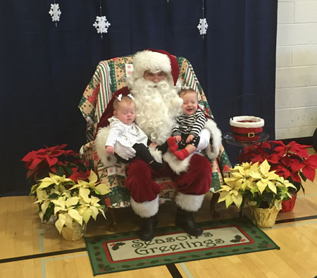 Cooper and Camryn Beachy sit on Santas lap. 