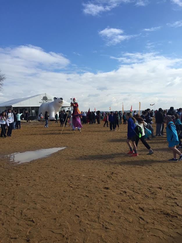 Plungers try to stay warm while on the sand of the Chesapeake Bay.