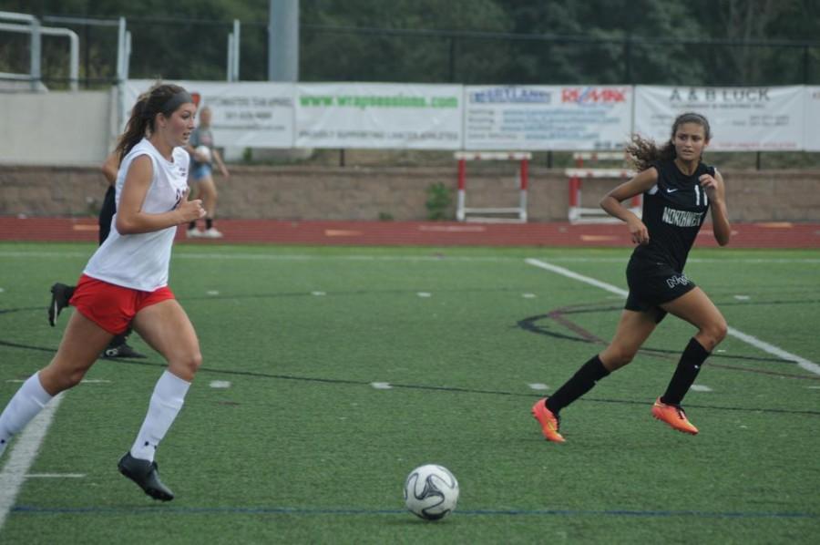 Montanna Hill heads to goal against Northwest .